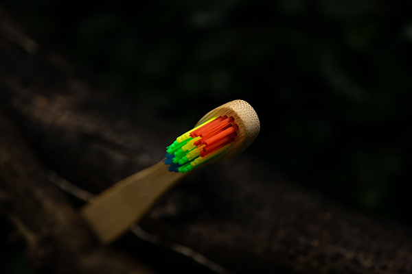 a wooden toothbrush with multiple colors